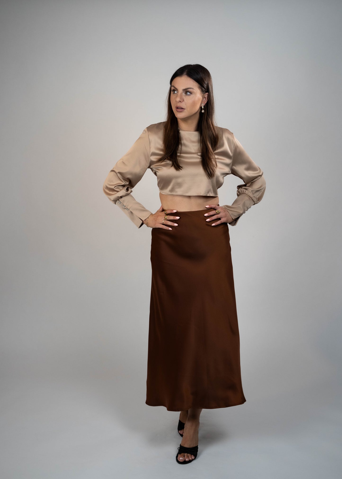 Elegant brown satin maxi skirt that’s easy to match with any outfit. Perfect for creating a sophisticated and versatile look