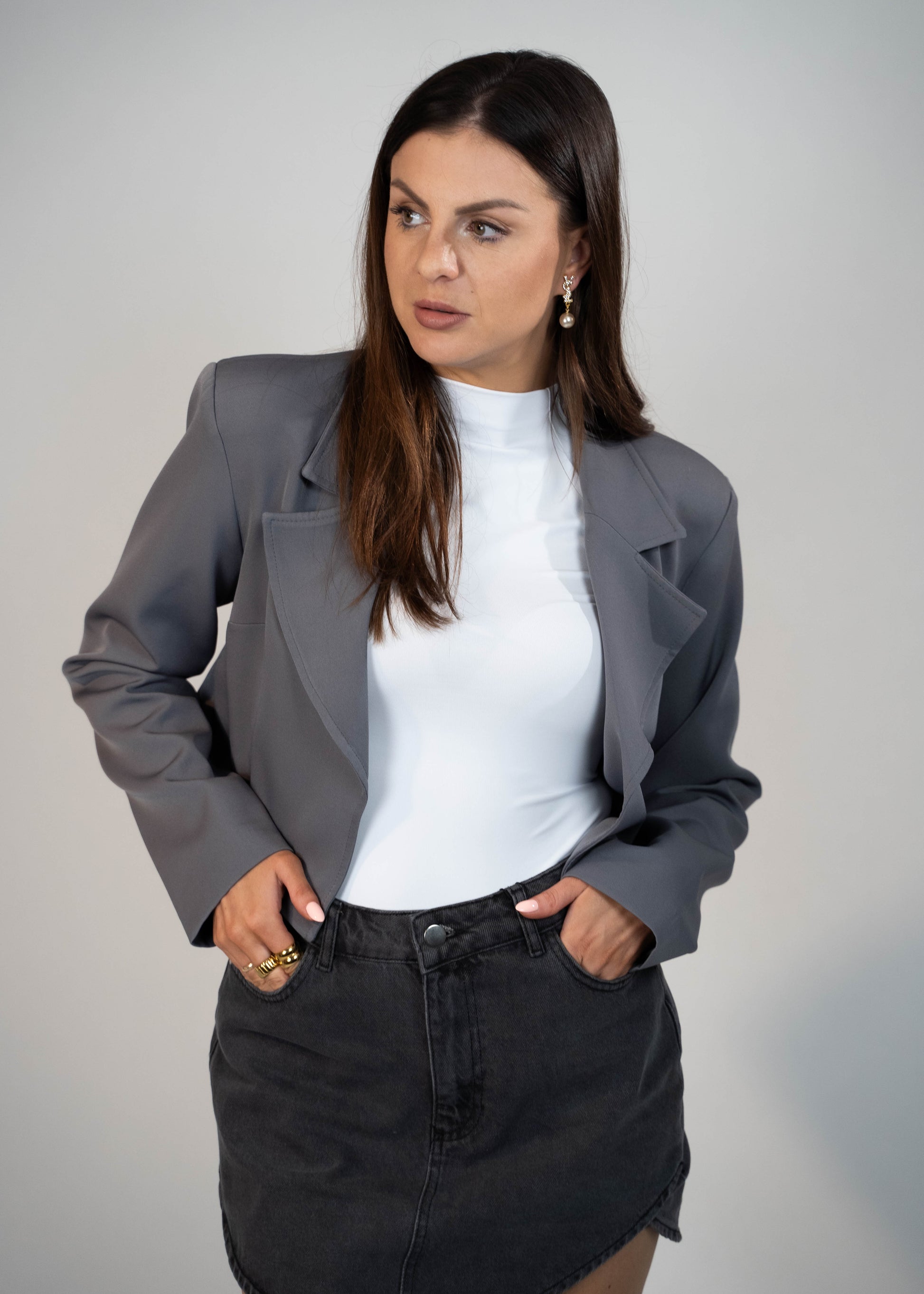 Crop Blazer Jacket for women in versatile gray. Featuring padded shoulders and a cropped design, this stylish jacket adds structure and sophistication to any outfit. Perfect for staying on trend and chic for any occasion