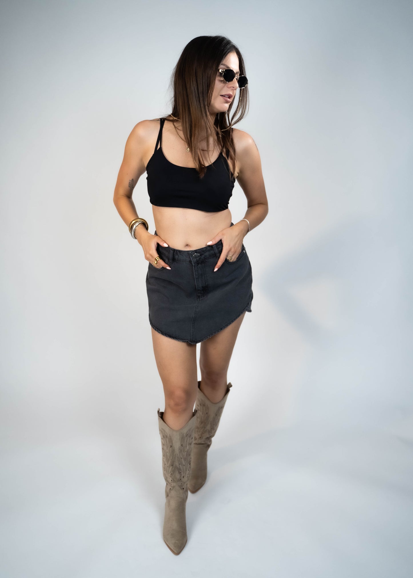 Asymmetric gray mini denim skirt designed to elongate legs and enhance your silhouette. Perfect for creating a flattering and stylish look