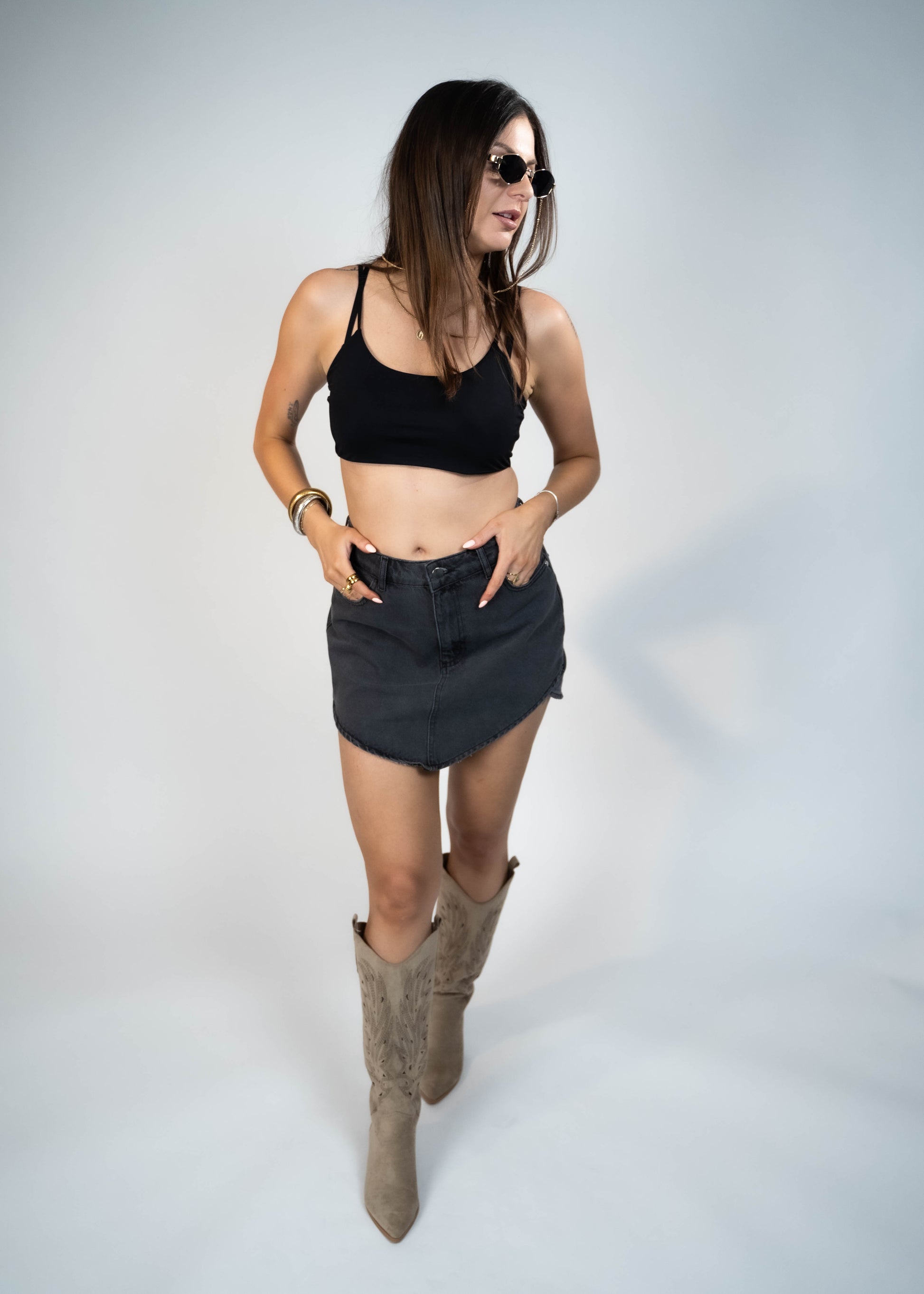 Asymmetric gray mini denim skirt designed to elongate legs and enhance your silhouette. Perfect for creating a flattering and stylish look