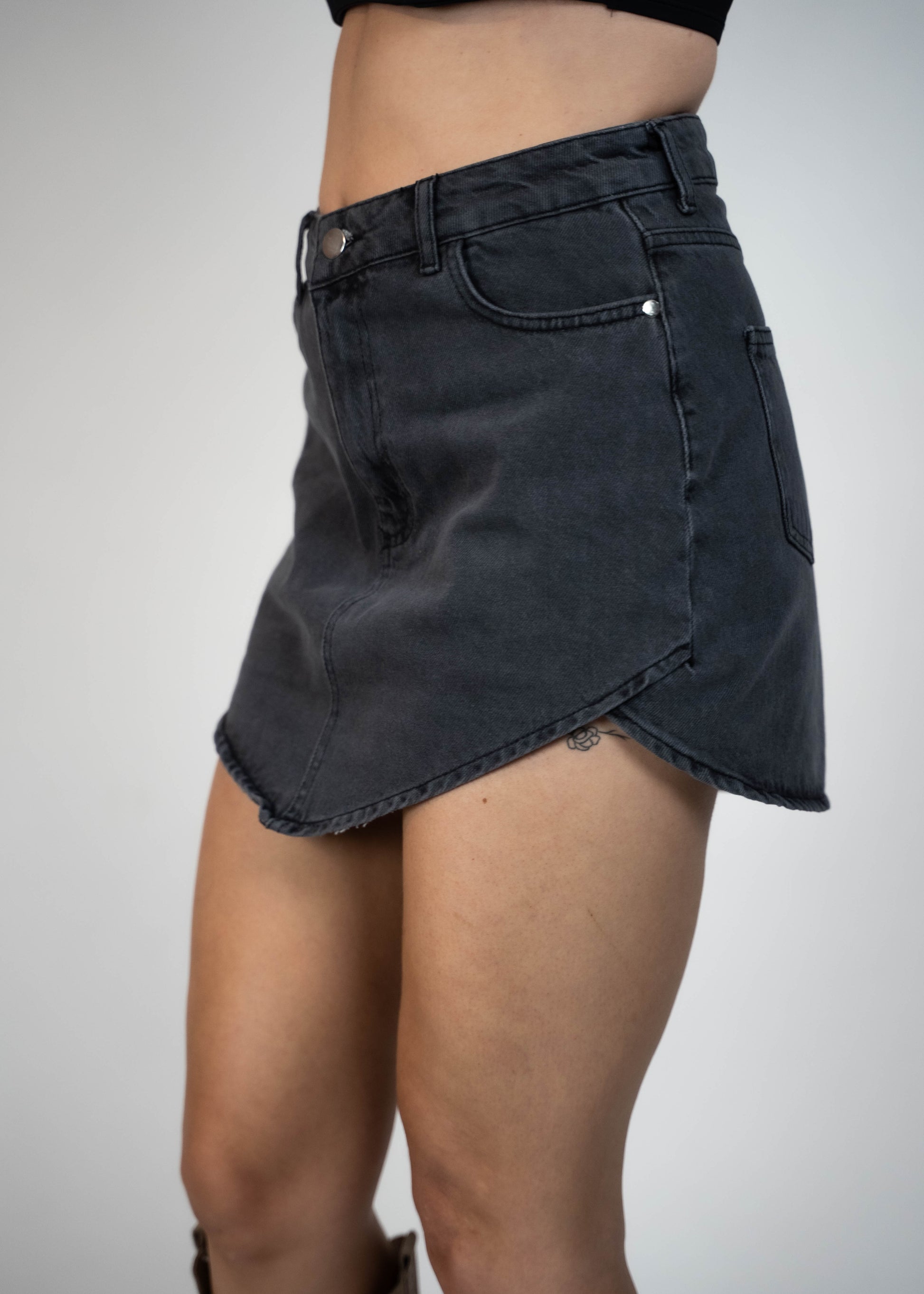Asymmetric gray mini denim skirt designed to elongate legs and enhance your silhouette. Perfect for creating a flattering and stylish look