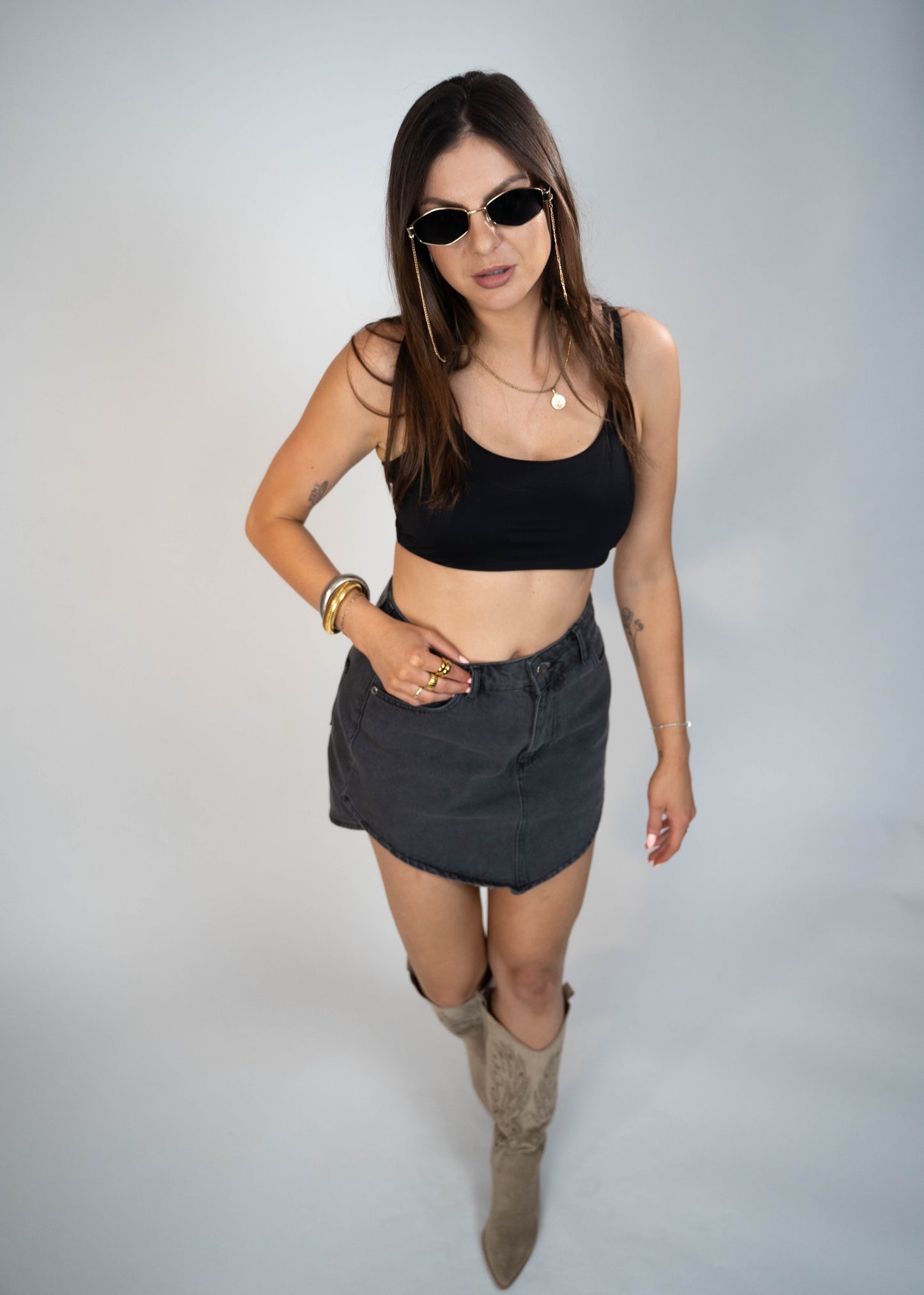 Asymmetric gray mini denim skirt designed to elongate legs and enhance your silhouette. Perfect for creating a flattering and stylish look