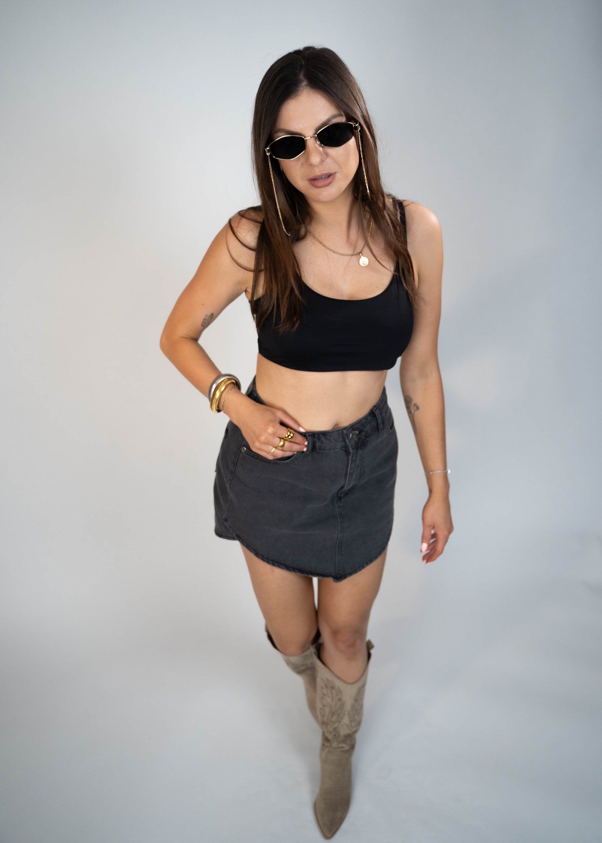 Asymmetric gray mini denim skirt designed to elongate legs and enhance your silhouette. Perfect for creating a flattering and stylish look