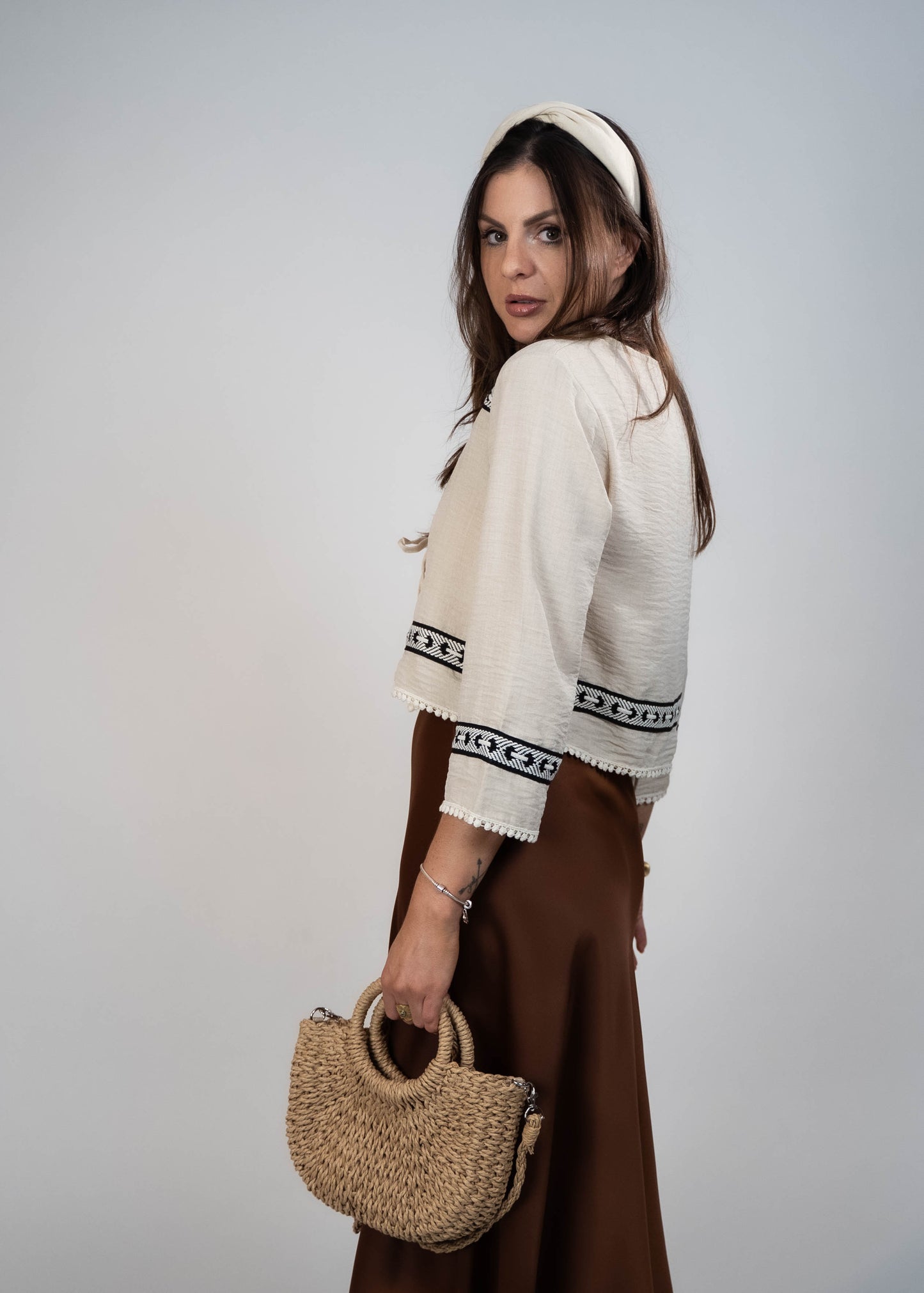 Trendy cream-colored front-tie top with 3/4 loose sleeves. Light and easy to style, featuring a chic front tie for added flair.