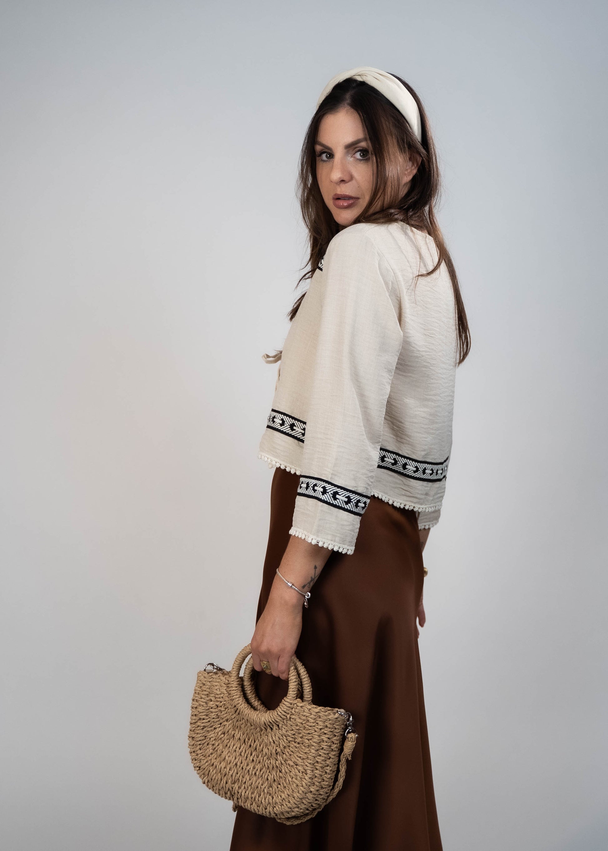 Trendy cream-colored front-tie top with 3/4 loose sleeves. Light and easy to style, featuring a chic front tie for added flair.