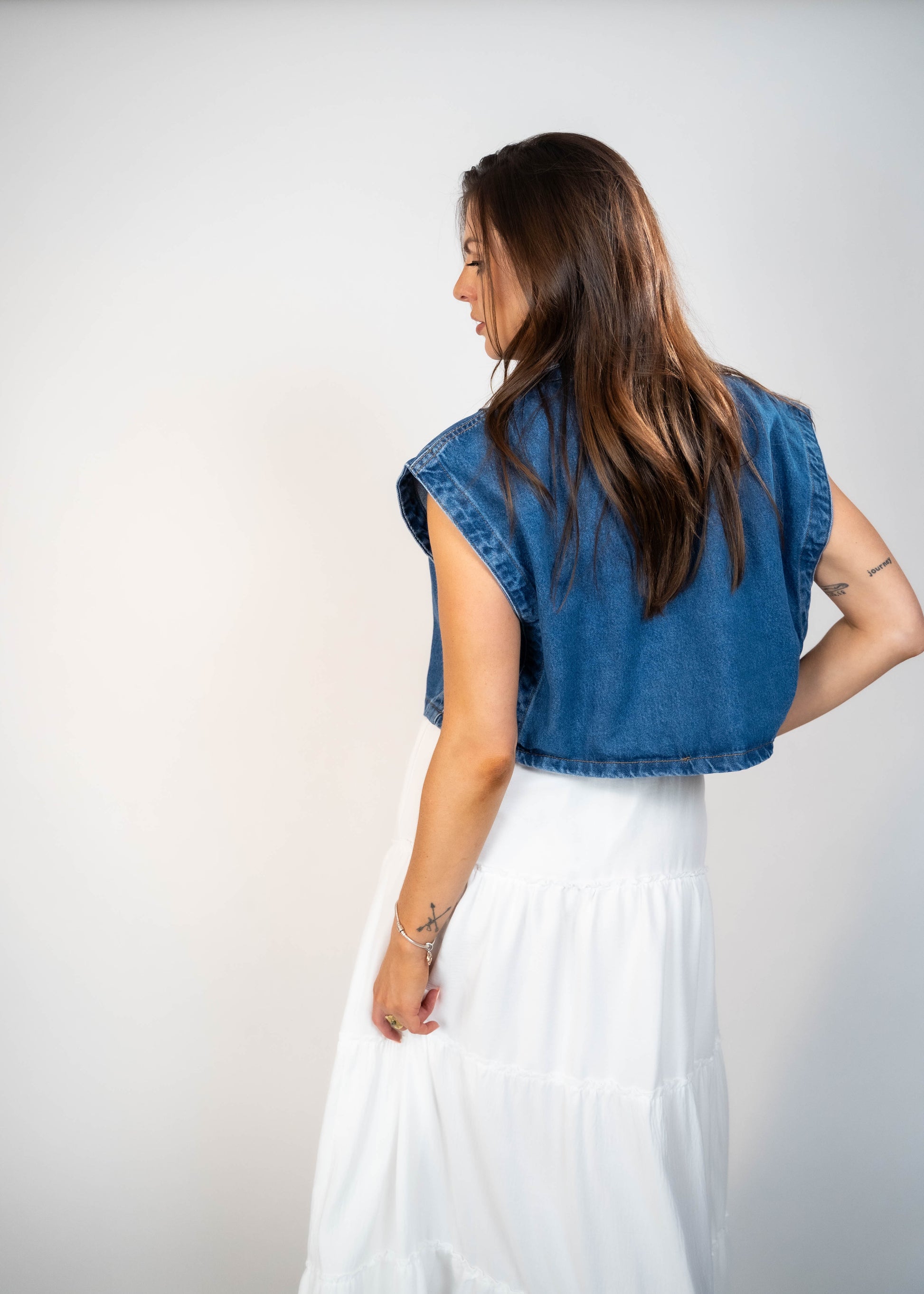 Blue loose-fit denim vest with structured shoulders, perfect for adding a relaxed and casual touch to any outfit