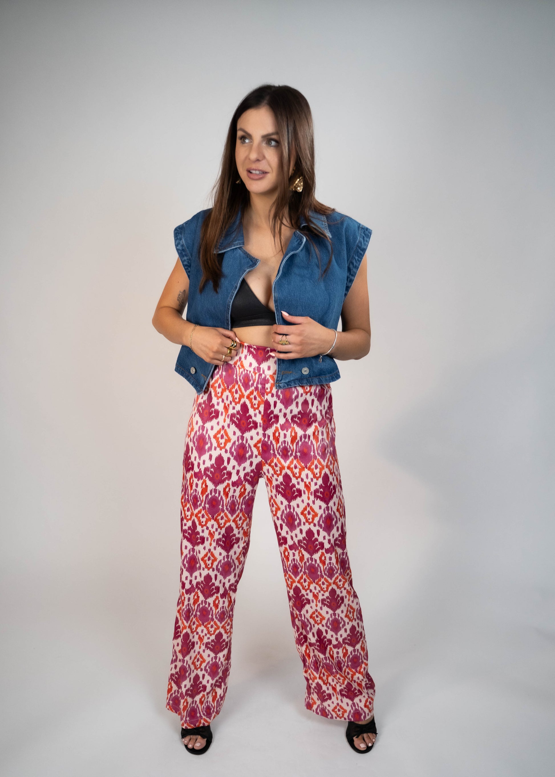 Elegant pink high-waisted flowy pants made from silky fabric, perfect for a chic and comfortable look. Ideal for both casual and formal outfits. Shop now for stylish and versatile wardrobe essentials