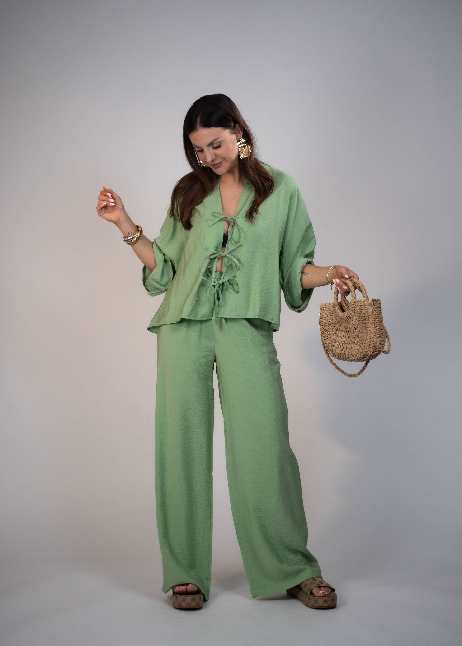 European style Palazzo Set featuring a flattering long-sleeve front-tie blouse and wide-leg palazzo pants. Made with breathable fabric, this elegant ensemble is perfect for any occasion. Elevate your wardrobe with this must-have set
