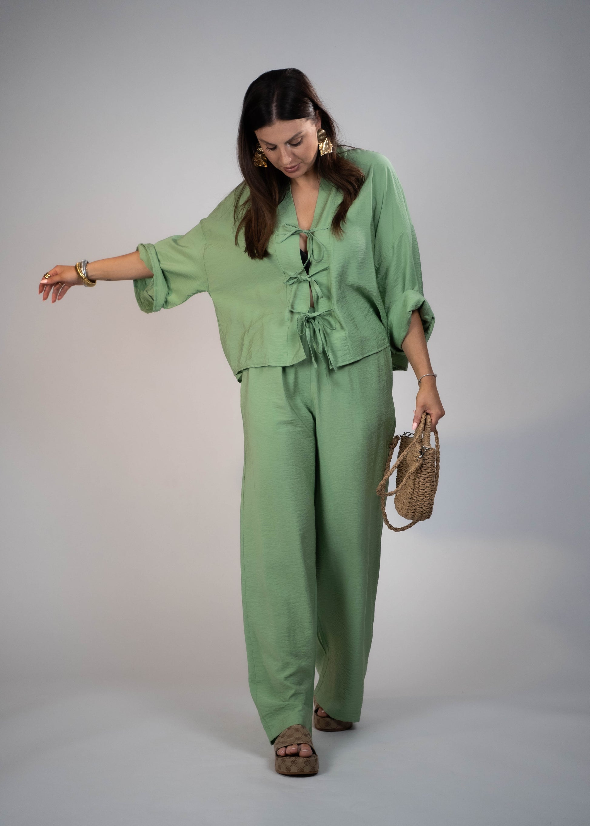 European style Palazzo Set featuring a flattering long-sleeve front-tie blouse and wide-leg palazzo pants. Made with breathable fabric, this elegant ensemble is perfect for any occasion. Elevate your wardrobe with this must-have set